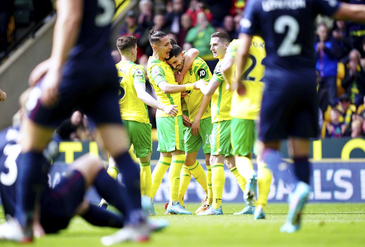 Norwich City's Pierre Lees-Melou, center, celebrates scoring with teammates during the English Premier League soccer match between Norwich City and Burnley at Carrow Road, Norwich, England, Sunday April 10, 2022. (Adam Davy/PA via AP)
