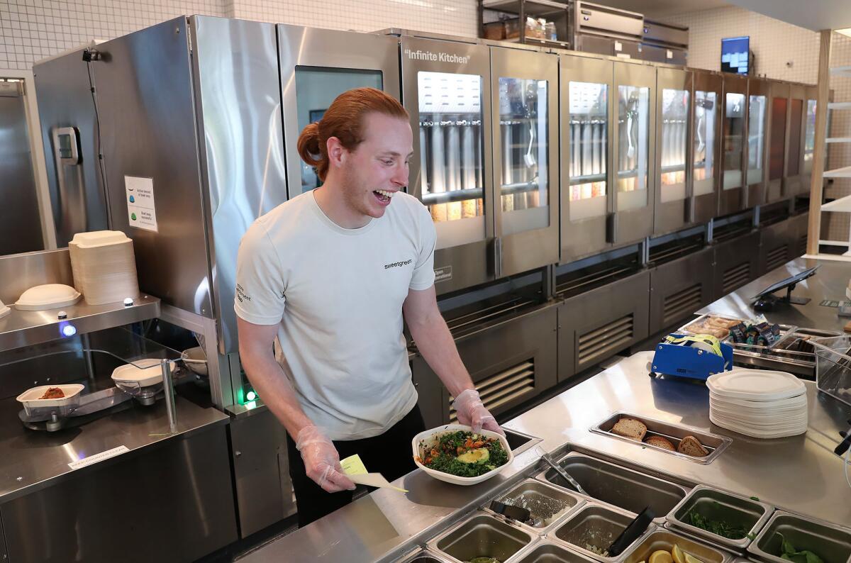 Kale Rogers, Sweetgreen director of concept automation, on the counter at Sweetgreen.