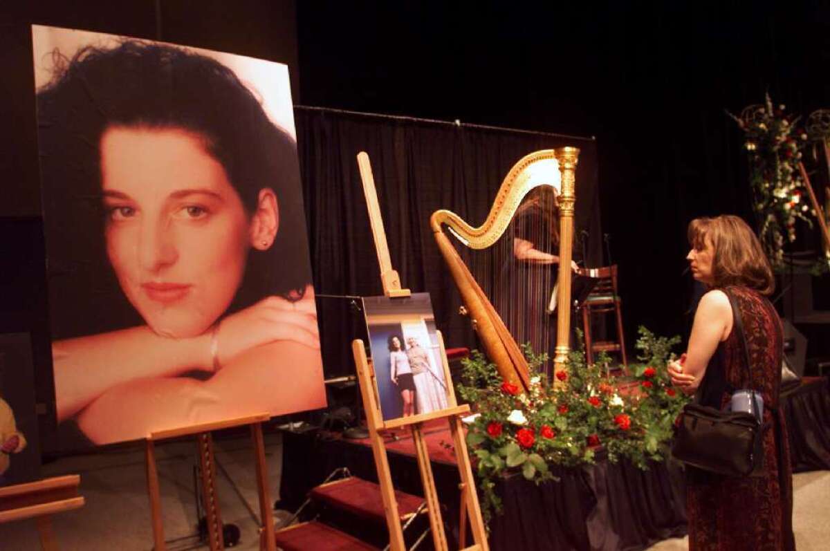 A mourner looks at a picture of Chandra Levy at a memorial service in Modesto in 2002.