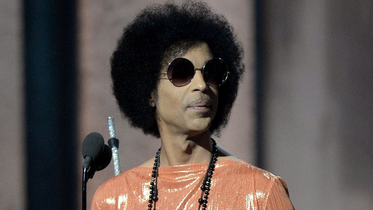 Prince presents an award at the 57th Annual Grammy Awards in Los Angeles.