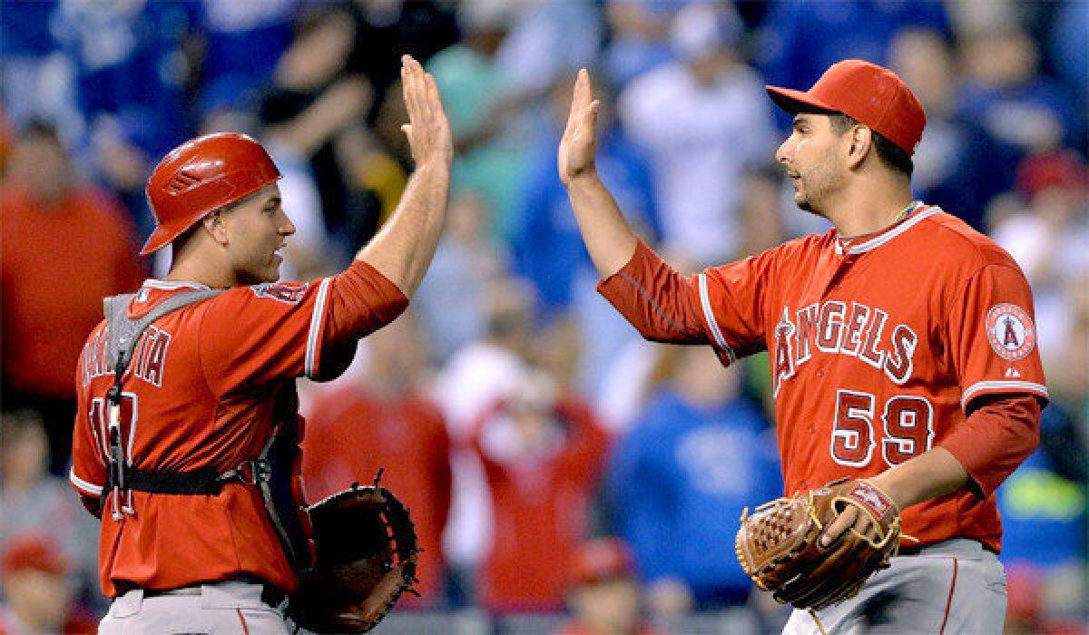 Angels reliever Robert Coello, right, will be shut down for a month after being placed on the 15-day disabled list Tuesday with shoulder inflammation.