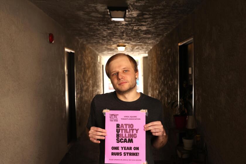LOS ANGELES, CA - AUGUST 19, 2026 - - Tenant Joe Porter, 29, shows one of the fliers that residents posted on their front doors at the Virgil Square Apartments where many of the residents, including Porter, are refusing to pay utility bills for a year until their property manager shows them the calculations being used in Koreatown in Los Angeles on August 19, 2026. The fliers remained for several weeks until the tenants, who posted them, received a 3 day notice to remove or be evicted. Tenants, at a master-metered buildings, are being denied the right to see the math behind their utility bills, even as these utility bills, in some cases, skyrocket. The Los Angeles Housing Department in December recommended restricting this kind of utility billing, also known as ratio utility billing systems, but no action has been taken. (Genaro Molina/Los Angeles Times)