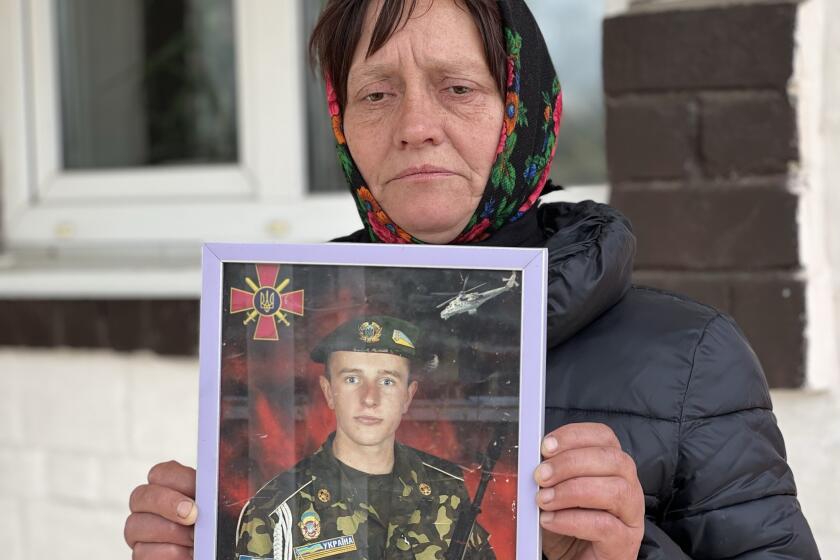 Olena Balai holds a photo of her only son, Viktor Balai, a 28-year-old veteran of the war, in Zdvyzhivka, Ukraine on April 30, 2022. Olena identified his body in eastern Ukraine's Donbas region, on the forest floor. "His brain was leaking out of his head," she said. "The face and mouth were torn apart, the teeth knocked out. There was no space left alive on his body. What pain he bore." She was weeping even as she spoke, her voice a wail of words. "Who would torture a kid?" she said. "I want them to be found and punished." Viktor was her only son. "I have no one else," she said, struggling to breathe. "I don't know how to continue my life." (AP Photo/Erika Kinetz)