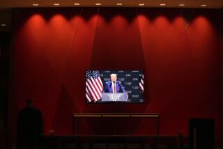 A video monitor in the lobby shows Republican presidential nominee former President Donald Trump speaking at a campaign event at the Cobb Energy Performing Arts Centre, Tuesday, Oct. 15, 2024, in Atlanta. (AP Photo/Alex Brandon)