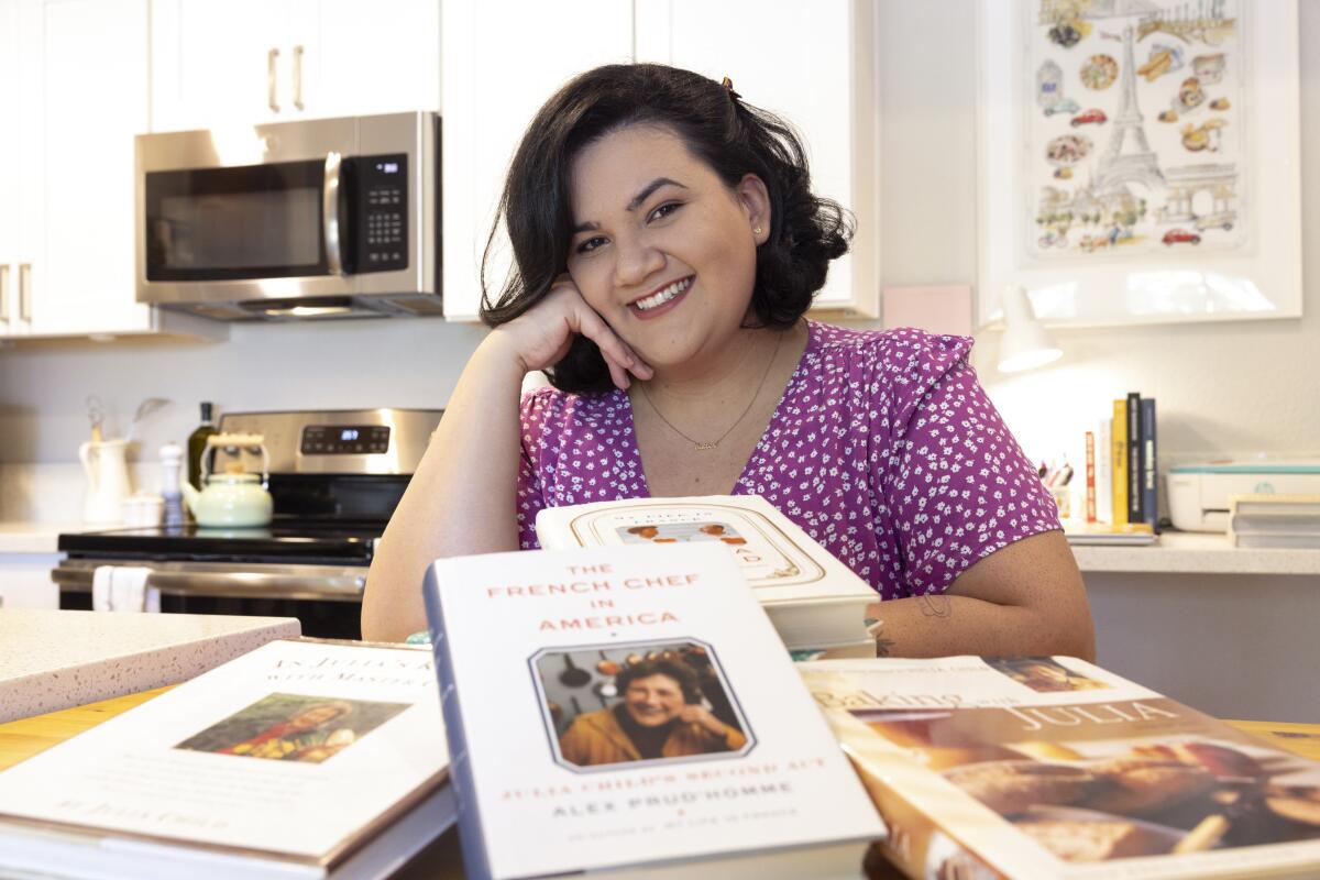 Oceanside resident Jaíne Mackievicz-Cenc with some of her Julia Child cookbooks.