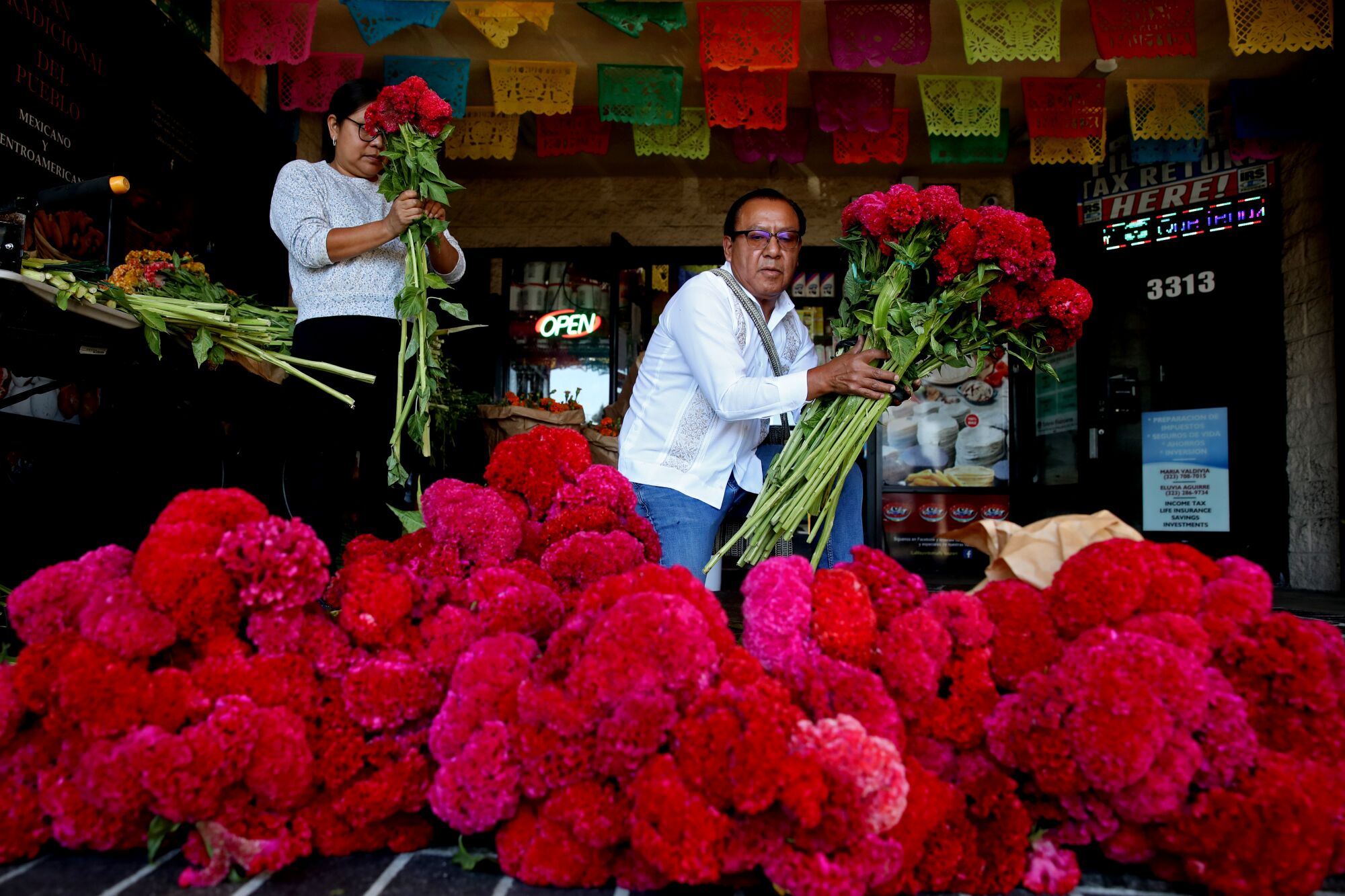 A man and a woman with flowers.