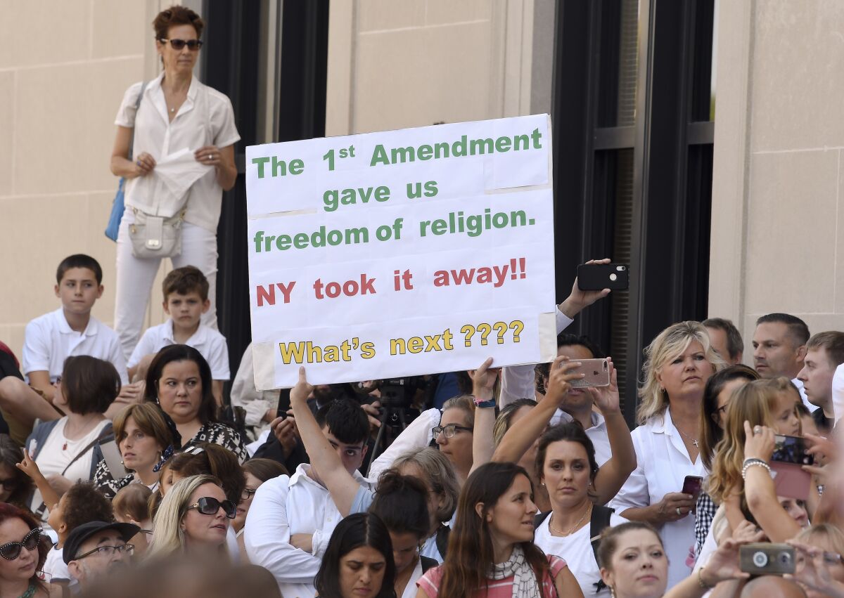 People protest New York's repeal of the religious exemption to vaccination in Albany on Aug. 14, 2019. 