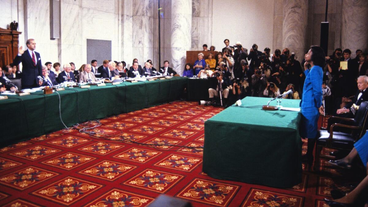 Anita Hill is sworn in by Sen. Joe Biden to testify before the Senate Judiciary Committee on the confirmation of Clarence Thomas to the Supreme Court in 1991.