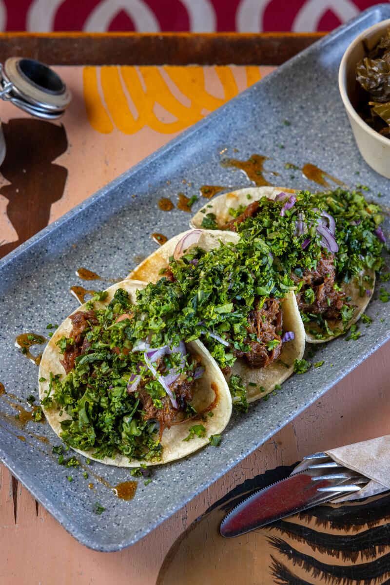 A rectangular dish with three tacos