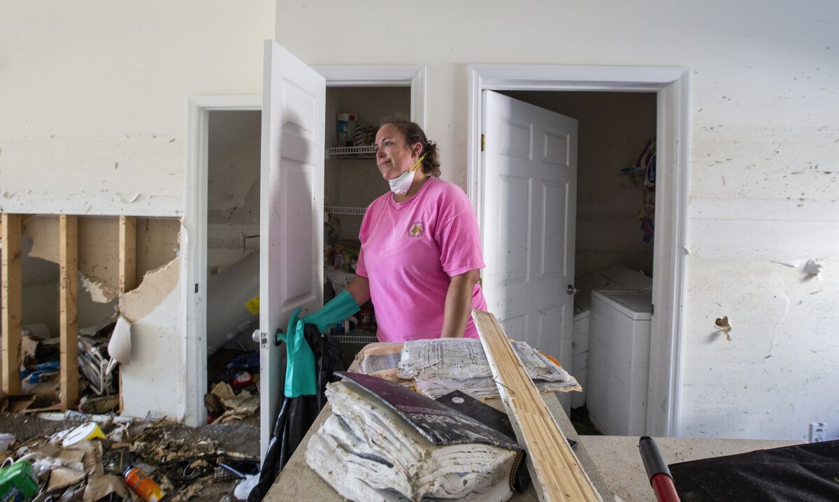 Erin Crawson, inside her townhouse in Mexico Beach where a neighbor's family Bible that washed in with the surge from Hurricane Michael lies on the counter.