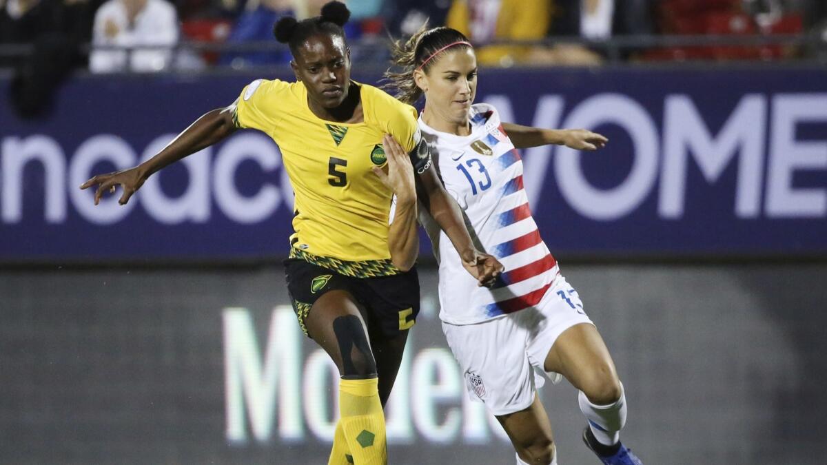 United States forward Alex Morgan, right, and Jamaica defender Konya Plummer attempt to gain control of the ball during the first half of the CONCACAF women's World Cup qualifying tournament in Frisco, Texas on Sunday.