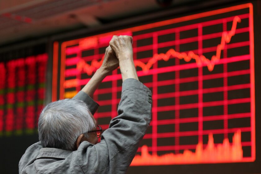 A stock investor reacts in front of an electronic screen showing the stock composite index Aug. 27 at a brokerage house in Beijing. The Shanghai Composite Index jumped 5.3%.
