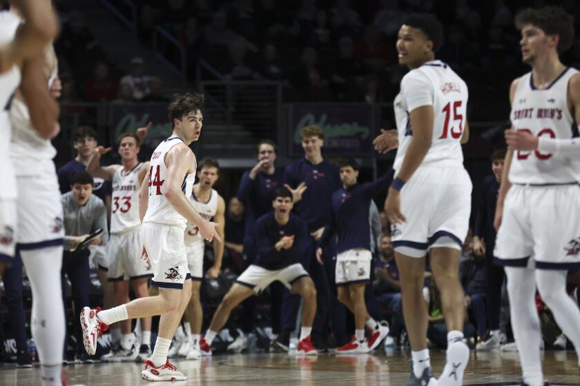 St. Mary's guard Alex Ducas (44) celebrates after scoring a 3-point basket during the first half of an NCAA college basketball game against Santa Clara in the semifinals of the West Coast Conference men's tournament Monday, March 11, 2024, in Las Vegas. (AP Photo/Ellen Schmidt)