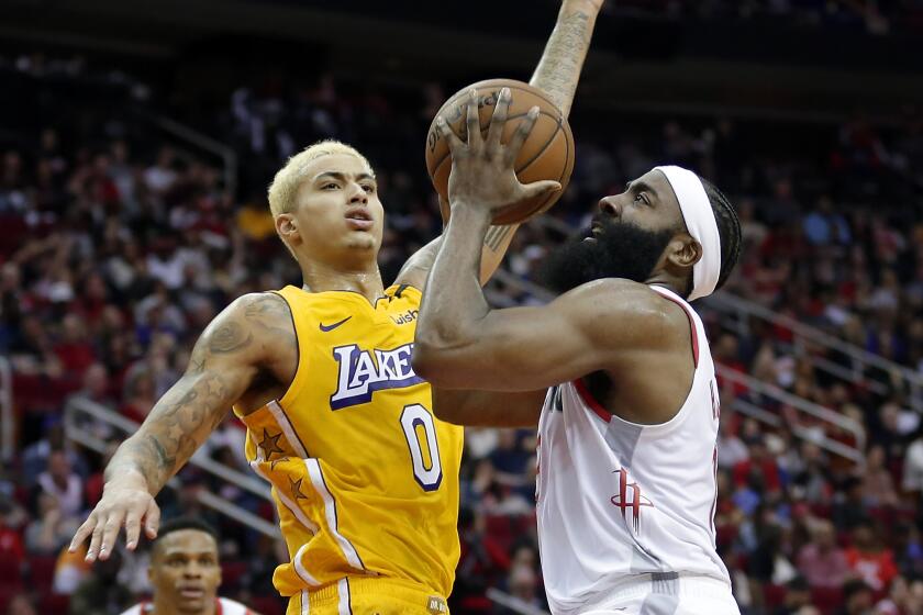 Lakers forward Kyle Kuzma pressures Rockets guard James Harden into a shot during the second half of a game Jan. 18 at Toyota Center.
