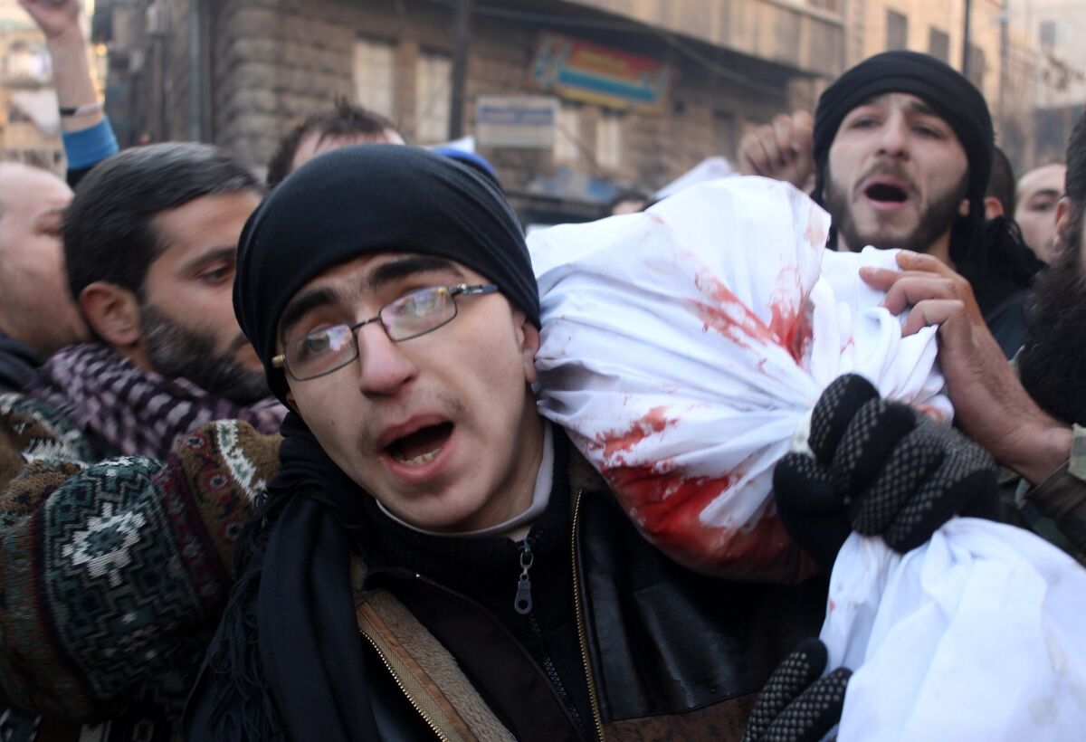 Mourners carry the body of a comrade killed during Syrian rebel battles in the northern city of Aleppo, on Jan. 8, 2014.
