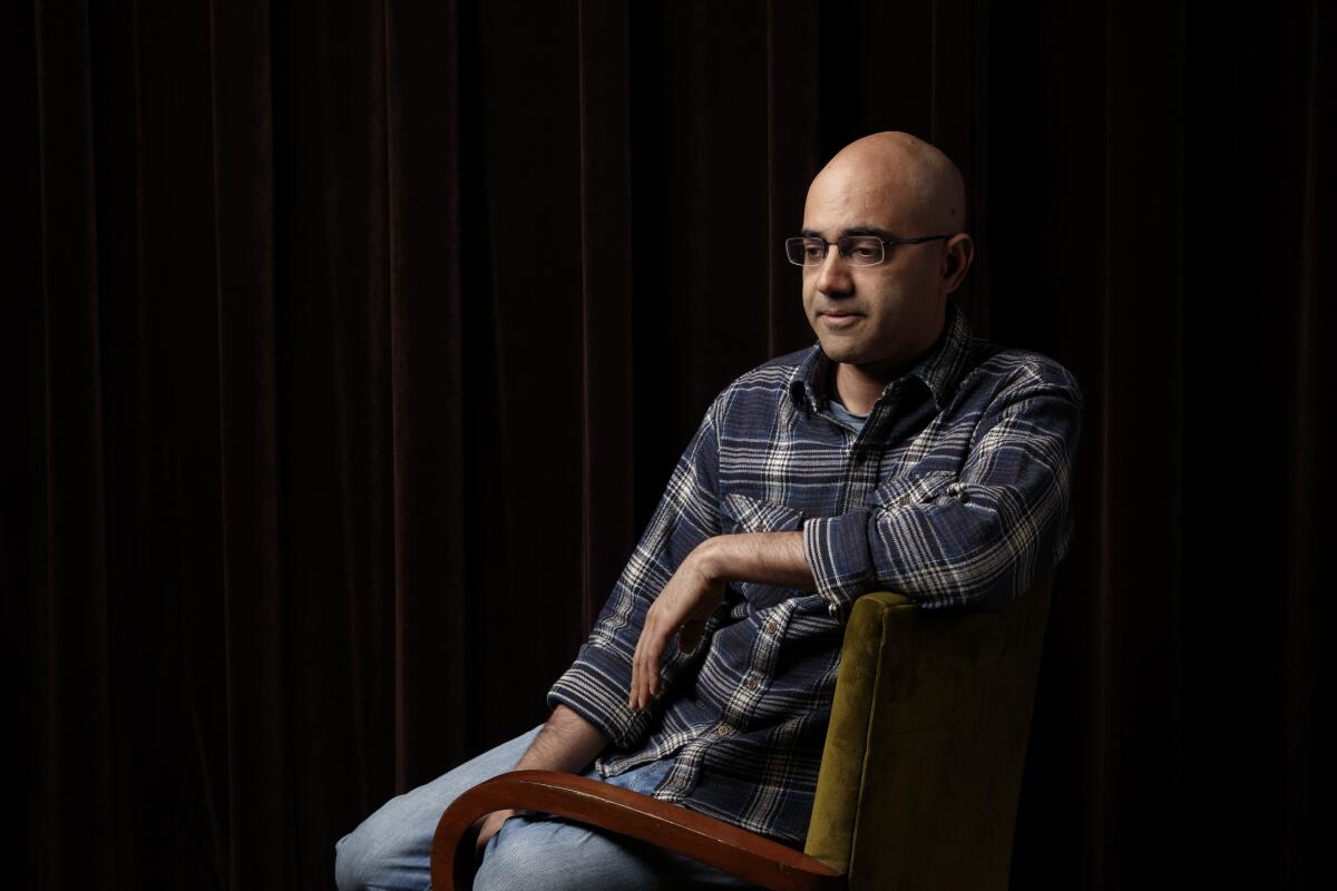 Writer Ayad Akhtar sits in a chair.