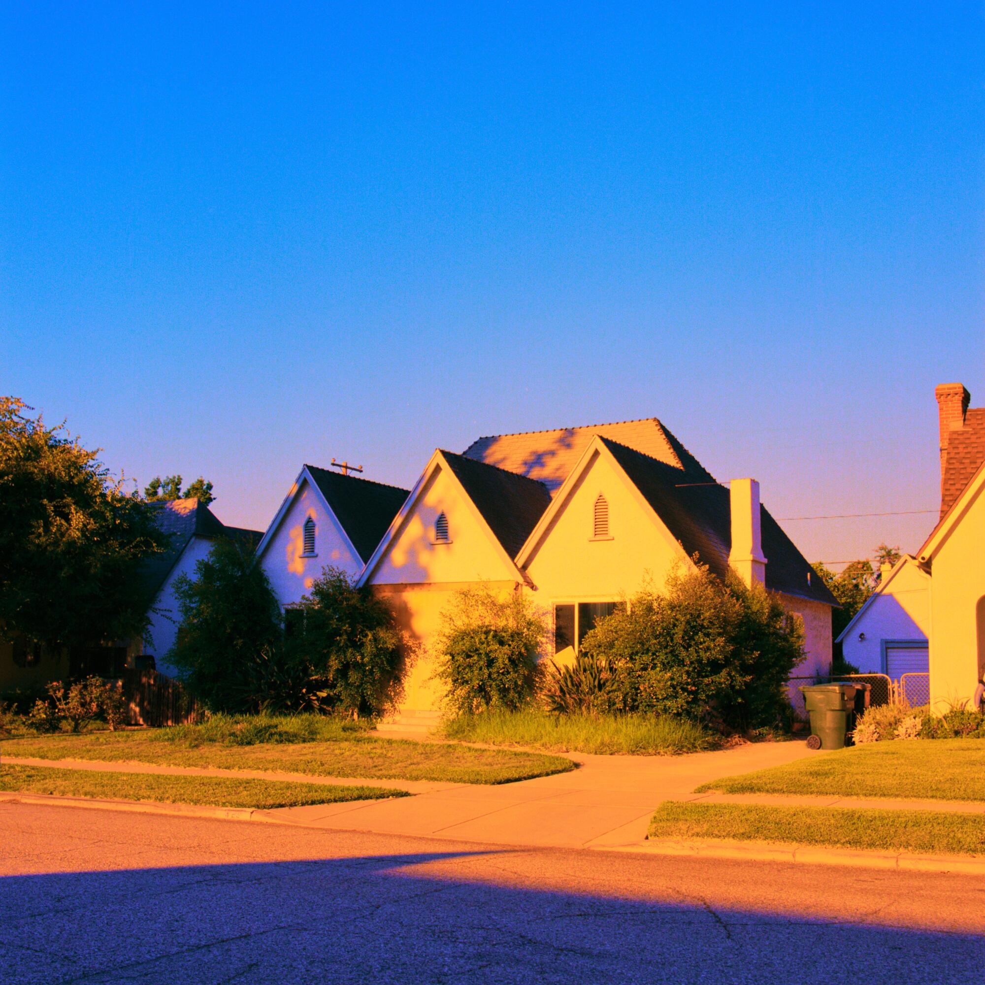 A photo of houses with triangular rooftops.