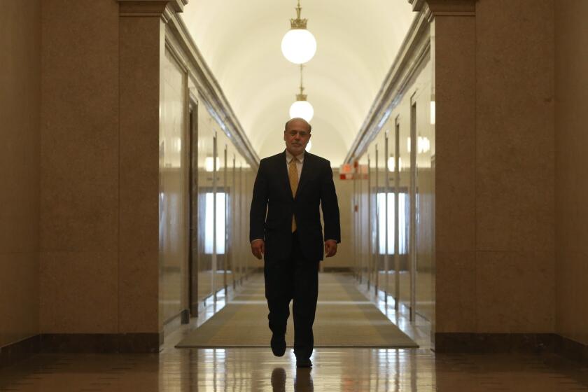 Federal Reserve Chairman Ben S. Bernanke walks out of his Washington, D.C., office Friday for the last time as head of the central bank.