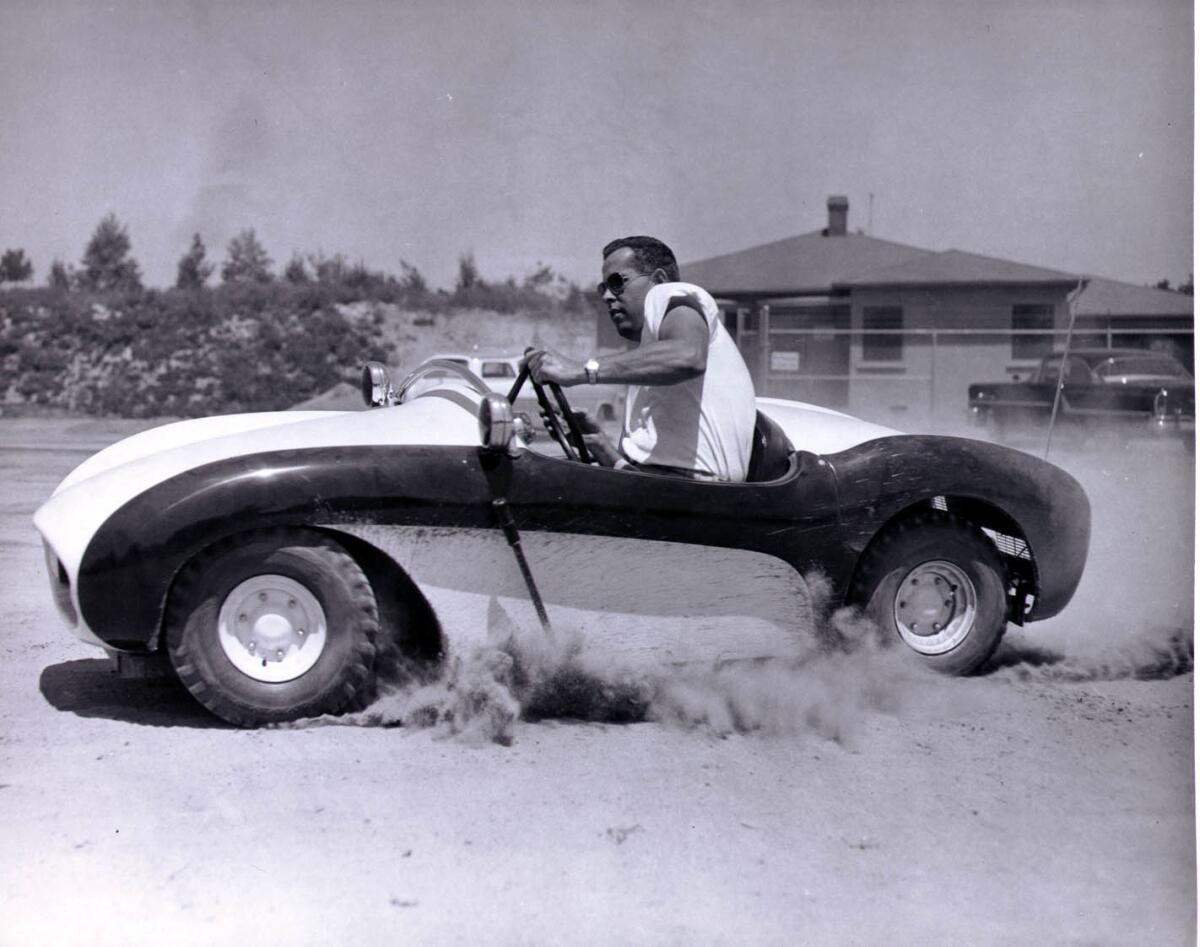 Bob Gurr test-drives an Autopia ride vehicle in 1955.