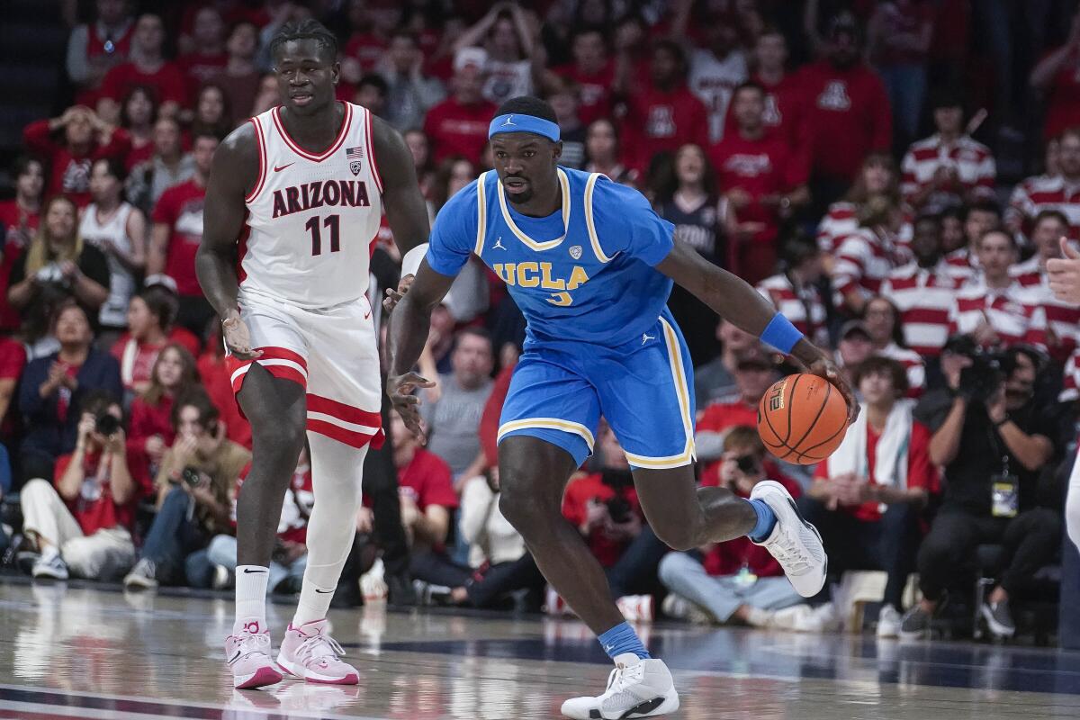 UCLA's Adem Bona drives to the basket after stealing the ball from Arizona's Oumar Ballo during the first half Saturday.