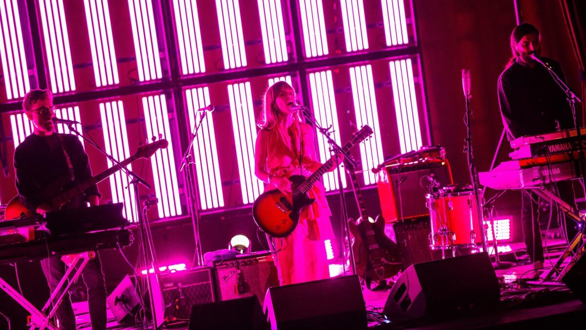 Feist, center, performs Friday night at the Palace Theatre in downtown Los Angeles.