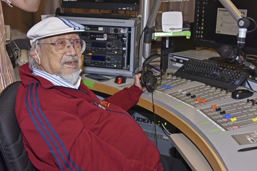 In this photo provided by Radio Television Hong Kong (RTHK), Ray Cordeiro, also known as Uncle Ray, gestures after he finished his last show "All The Way with Ray" at the studio in RTHK, the broadcaster in Hong Kong on Feb.15, 2021. After more than seven decades in radio, the 96-year-old Hong Kong DJ bid farewell to his listeners Saturday, May 15, 2021 with “Time to Say Goodbye,” sung by Sarah Brightman and Andrea Bocelli. (Radio Television Hong Kong via AP)