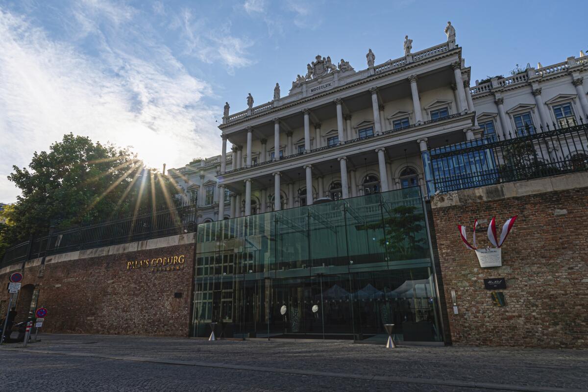 The sun sets behind the Palais Coburg where closed-door nuclear talks take place in Vienna, Austria, Friday, Aug. 5, 2022. A new round of talks on the revival of the Joint Comprehensive Plan of Action (JCPOA) began in Vienna on Thursday. (AP Photo/Florian Schroetter)