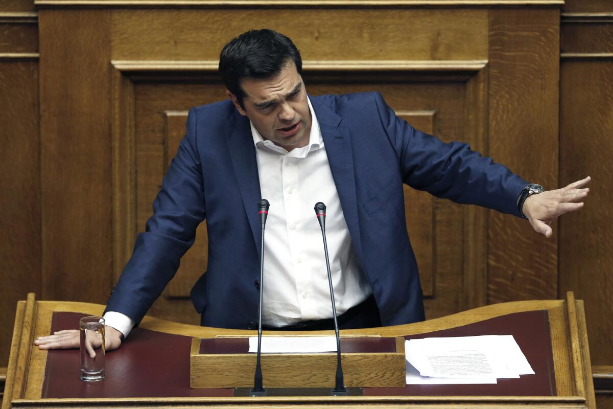 Greek Prime Minister Alexis Tsipras speaks during an emergency session of Parliament in Athens.