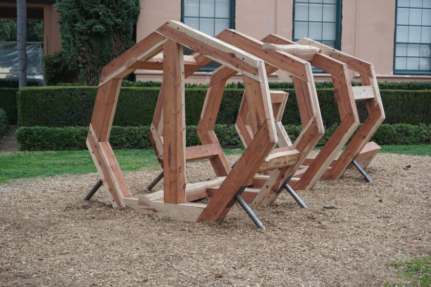 “Archive and Witness” by Trevor Amery consists of a framework of redwood timber beams in the shape of a fallen tree trunk.