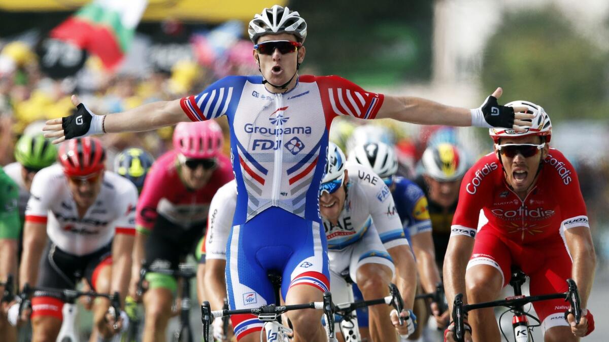 France's Arnaud Demare celebrates as he crosses the finish line to win Stage 18 of the Tour de France on July 26.