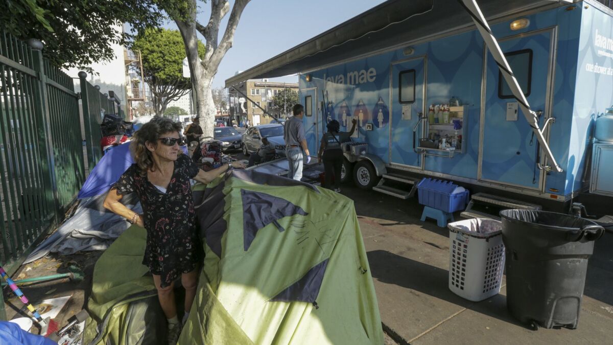 A mobile shower trailer on 6th Street outside Gladys Park in Los Angeles. Lava Mae, a nonprofit group, operates several such shower facilities around the county.