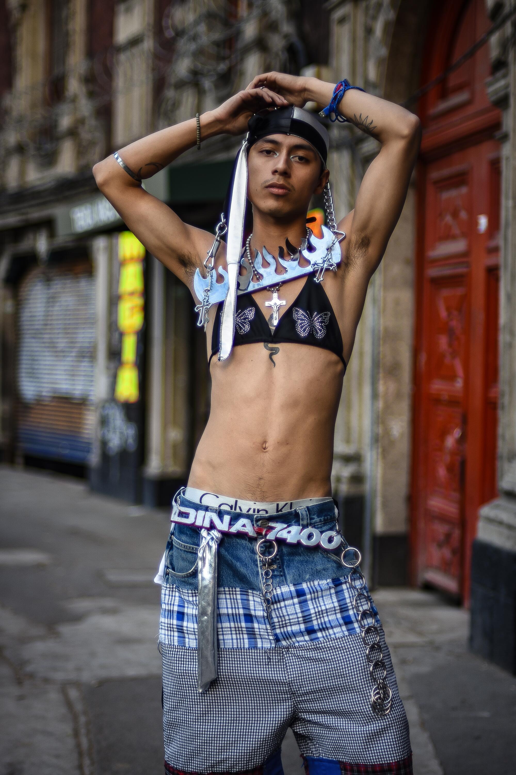 Axel wears Wavey mariposa bikini top, Planeta plaid block shorts.