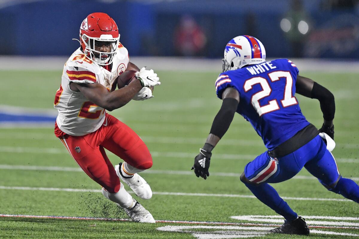 Kansas City Chiefs running back Clyde Edwards-Helaire runs the ball as Buffalo Bills cornerback Tre'Davious White defends.