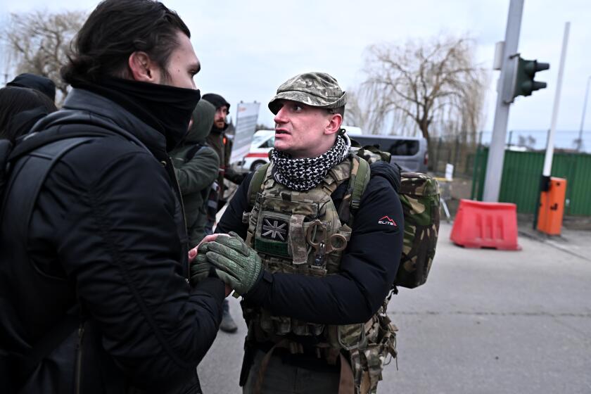 Medyka, Poland March 6, 2022: As refugees flee, a British volunteer fighter prepares to cross the border into Ukraine from Medyka, Poland Sunday. (Wally Skalij/Los Angeles Times)