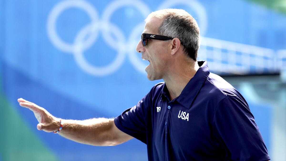 U.S. women's water polo Coach Adam Krikorian gives instructions to his players during a match against Spain on Tuesday.
