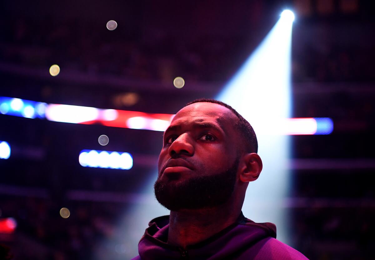Lakers forward LeBron James listens to the national anthem before a game on Jan. 5, 2020, at Staples Center.