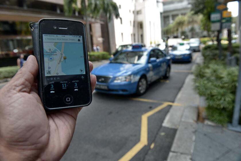 An Uber user in Singapore checks on the availability of a ride in October 2014.