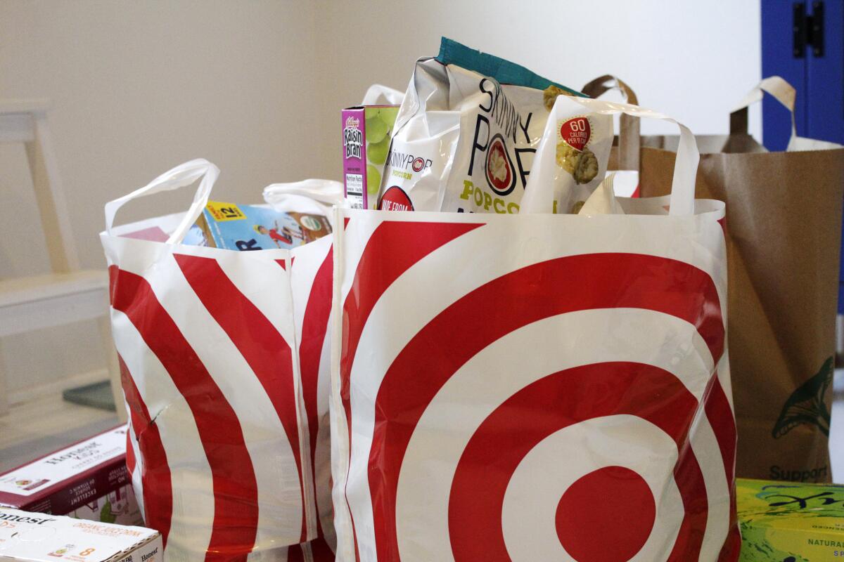 Two plastic bags containing groceries.