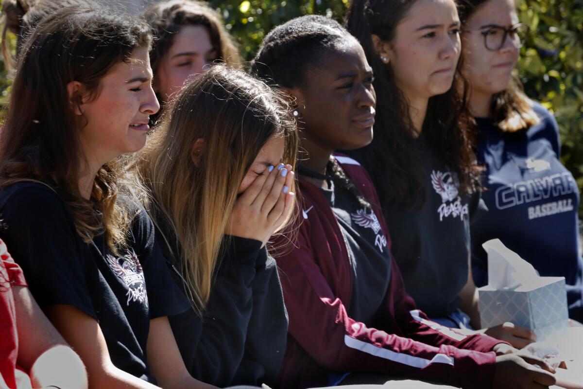 Students gather for a memorial in Coral Springs, Fla., one day after a gunman killed 17 people at Marjory Stoneman Douglas High School in nearby Parkland in 2018.