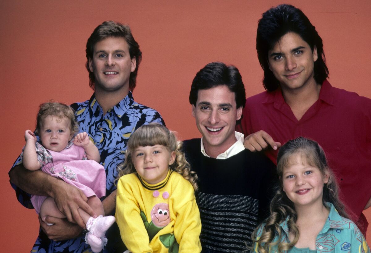 Mary-Kate/Ashley Olsen, left, Dave Coulier, Jodie Sweetin, Bob Saget, John Stamos and Candace Cameron in a gallery shot from the "Full House." A revival of the hit ABC sitcom will roll out on Netflix in February.