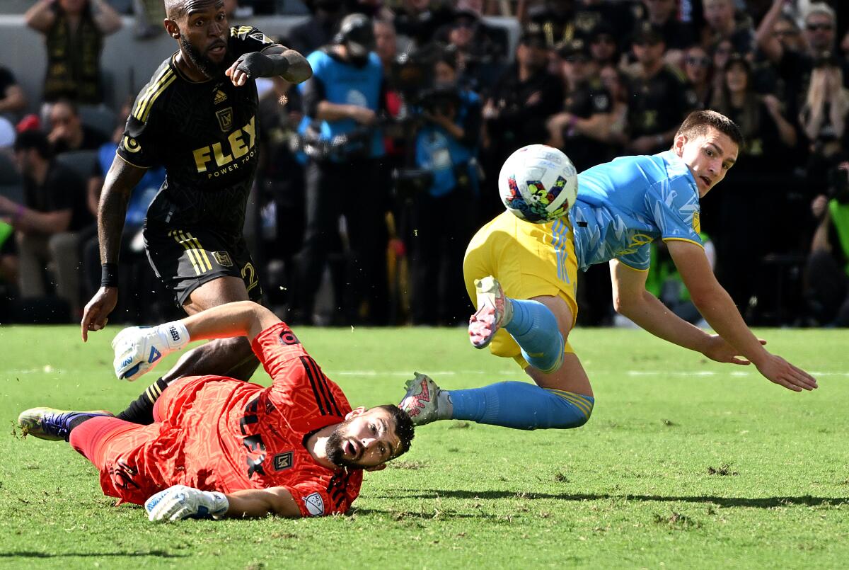 LAFC goalkeeper Maxime Crepeau (on ground) and Philadelphia Union's Mikael Uhre collide.