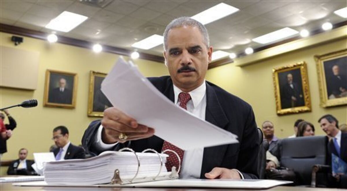 FILE - In this April 23, 2009 file photo Attorney General Eric Holder prepares to testify before the House Appropriations Committee on Capitol Hill in Washington. Justice Department officials have stopped short of recommending criminal charges against Bush administration lawyers who wrote secret memos approving harsh interrogation techniques of terror suspects. (AP Photo/Susan Walsh, File)