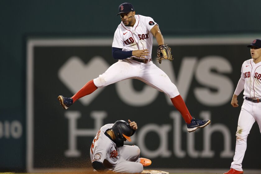 Baltimore Orioles' Rougned Odor (12) is forced out at second base as Boston Red Sox's Xander Bogaerts, top, turns the double play on Austin Hays to end the baseball game in the ninth inning, Tuesday, Sept. 27, 2022, in Boston. (AP Photo/Michael Dwyer)