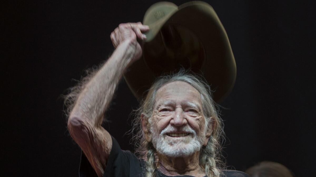 Willie Nelson tips his hat to the crowd as he takes the stage at the Stagecoach Country Music Festival in Indio in April. https://lat.ms/2C6uSLg