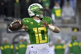Oregon quarterback Bo Nix looks for a receiver during the first half of the team's NCAA college football game against Utah on Saturday, Nov. 19, 2022, in Eugene, Ore. (AP Photo/Andy Nelson)