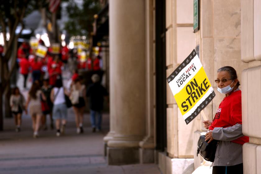 LOS ANGELES, CA - JULY 2, 2023 - A lone hotel worker pickets outside the Biltmore Hotel as members of Unite Here Local 11 joined dozens of other southland hotels who went on strike today in downtown Los Angeles on July 2, 2023. Hotel workers formed picket lines at many of the hotels in an effort to secure higher pay and improvements in health care and retirement benefits. The contract between the hotels and Unite Here Local 11 expired at 12:01 a.m. on Saturday (Genaro Molina / Los Angeles Times)
