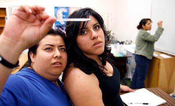 During class at L.A. Valley College, students Melody Lopez, left foreground, and Rocio Herrera check a thermometer, as does Estrada, far right. Among 21 students in class that day, 17 were immigrants from a range of countries: Mexico, India, Guatemala, Egypt, Honduras, Indonesia, Cuba, Congo, Ukraine and the tiny West African nation of Burkina Faso.