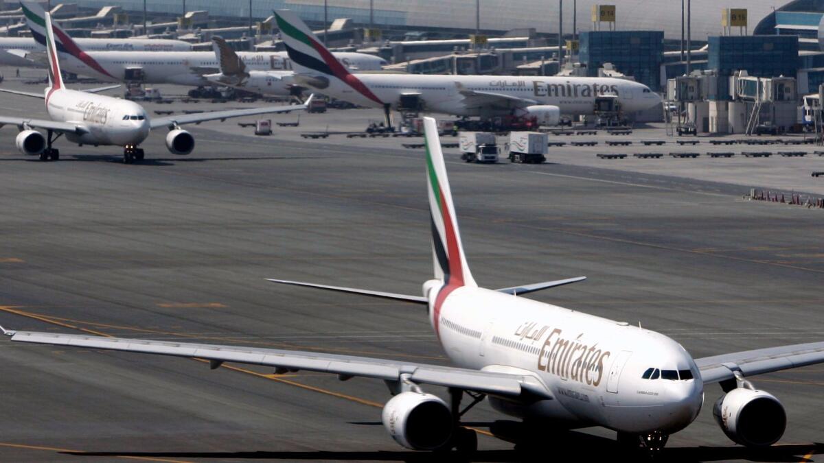 Emirates Airline jets taxi at Dubai International airport in Dubai, United Arab Emirates. Language added to a Senate bill may impose a new tax on Emirates and some other foreign carriers.