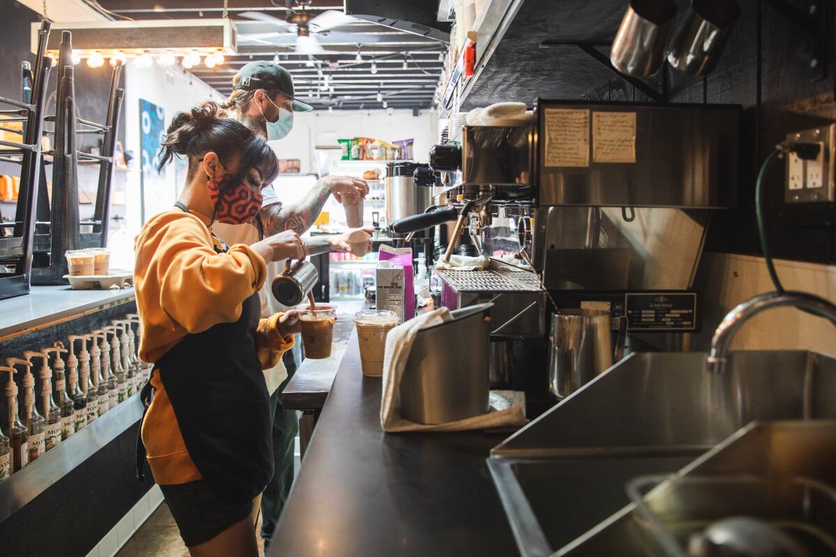 Minah Castillo, 22, and Ron Richie, 38, prepare drinks at Grindhouse located on Third Avenue in Chula Vista.
