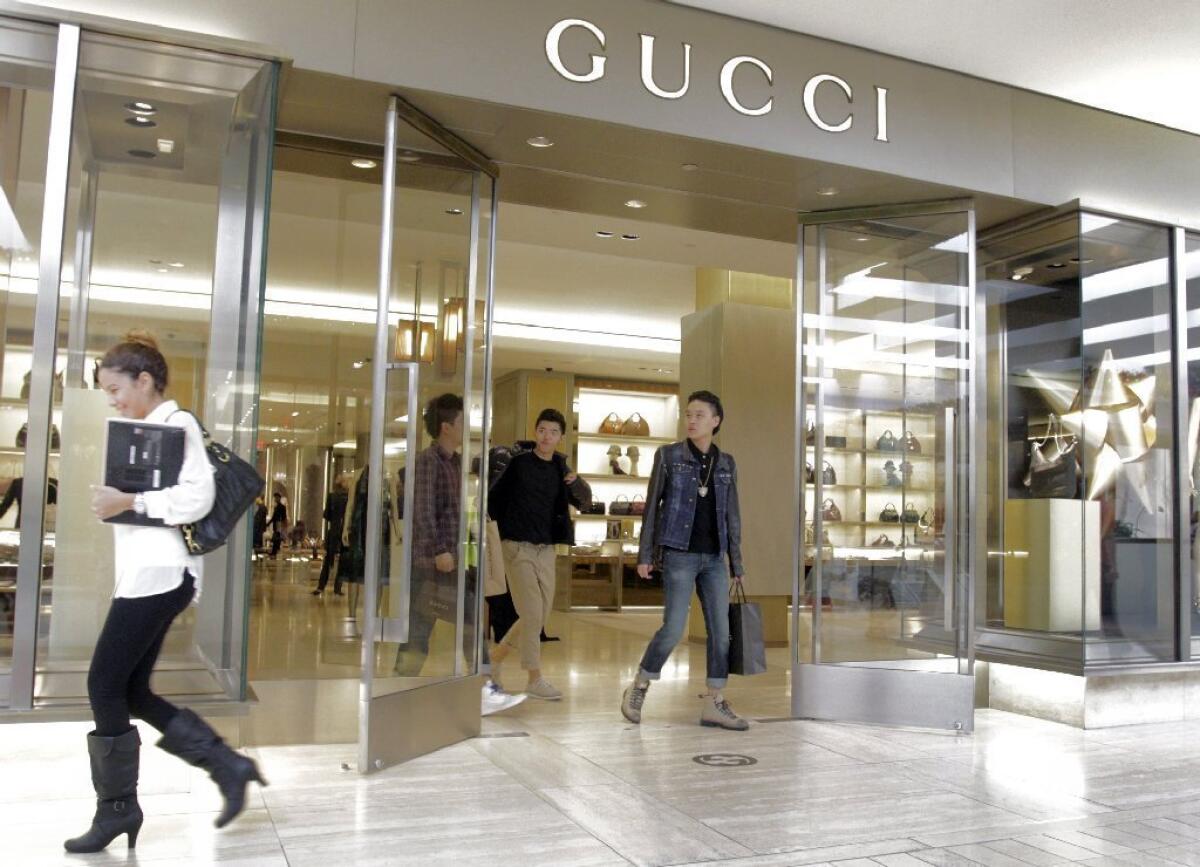 Shoppers outside Gucci store at South Coast Plaza in Costa Mesa. Consumer spending accounts for about 70% of the economy.